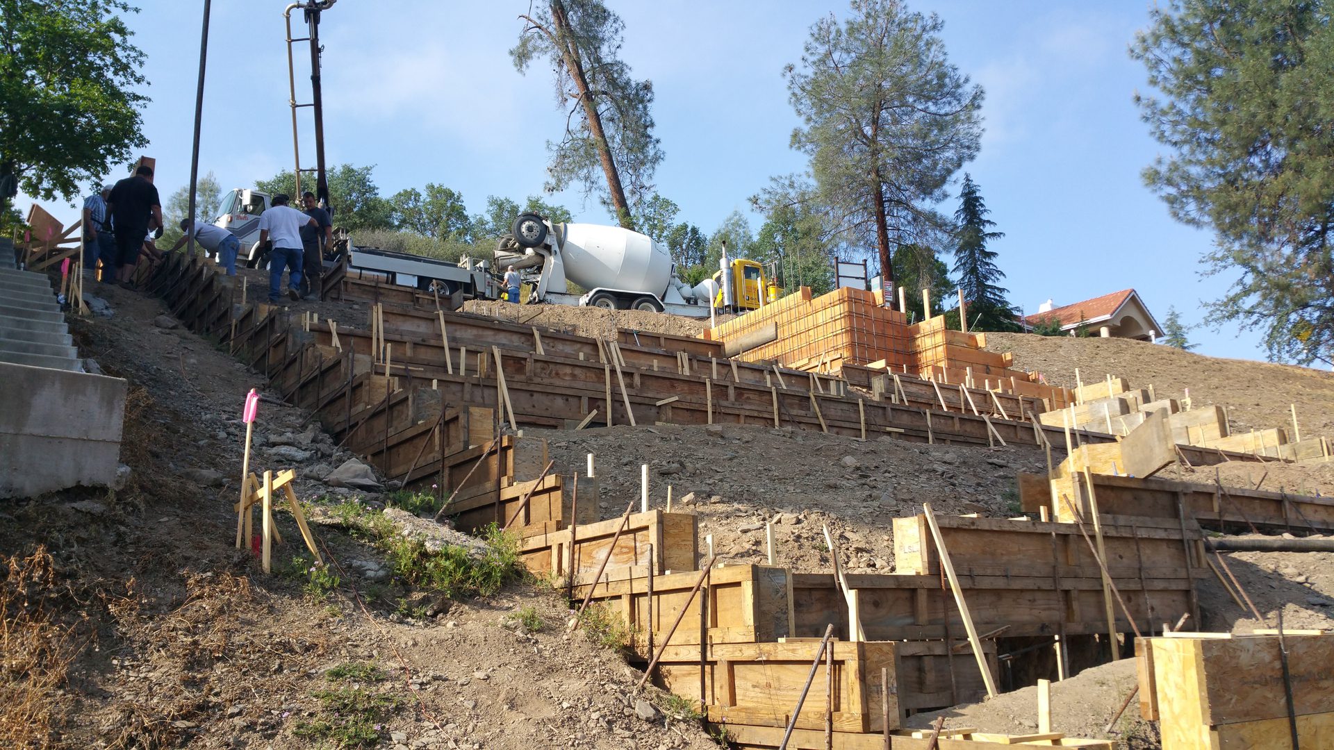 Construction workers on hillside project