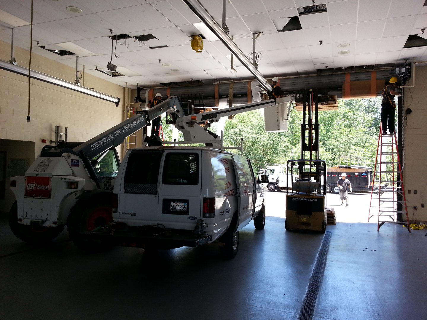 Workers repairing garage ceiling