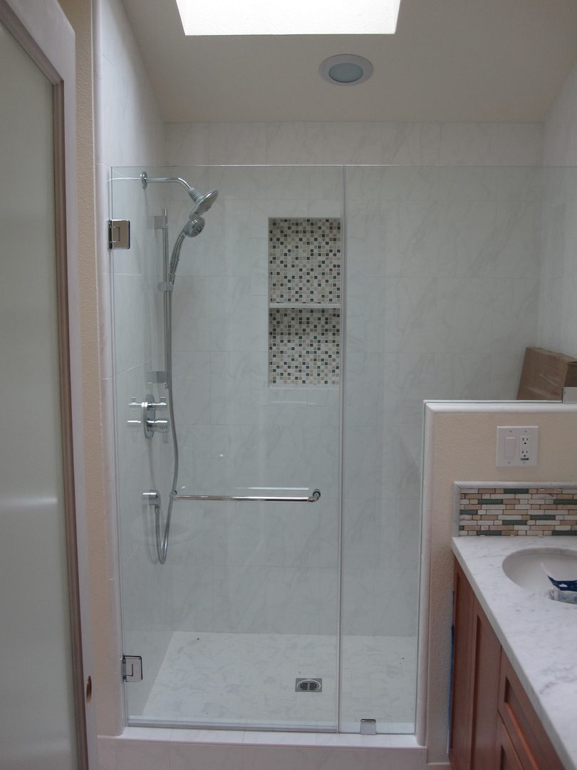 Elegant shower with mosaic tile accent