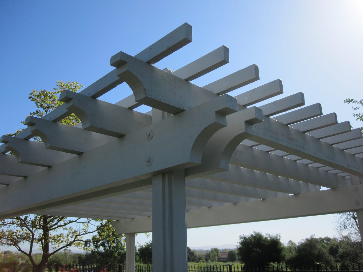 White pergola under clear blue sky