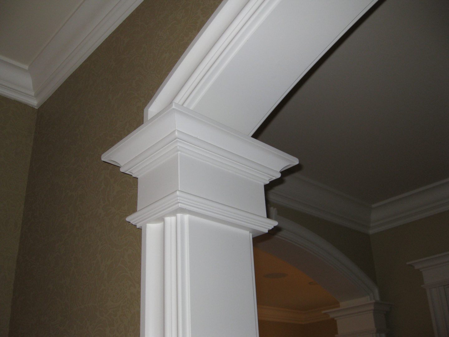 Elegant crown molding on white archway