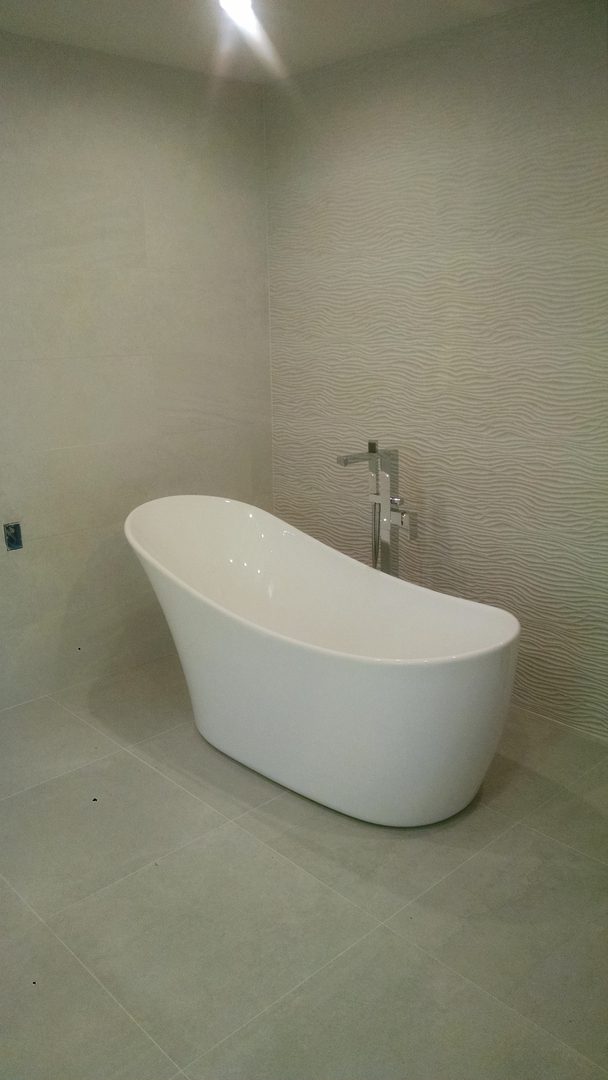 Freestanding white bathtub in modern bathroom