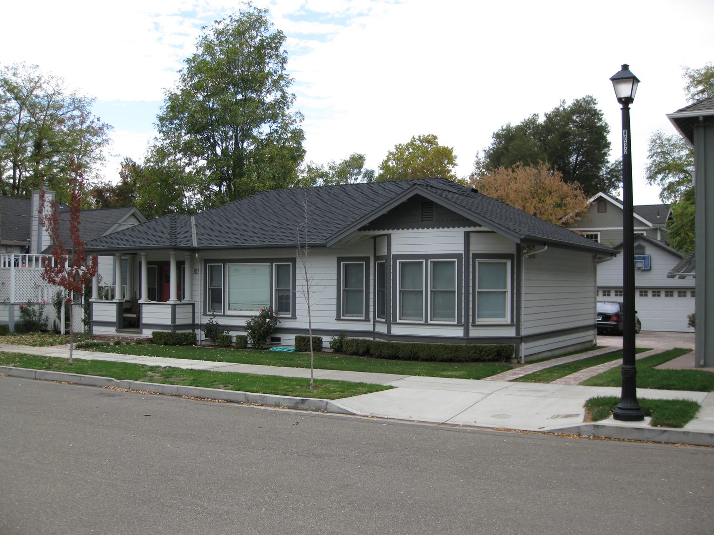 Residential neighborhood with a lamppost and sidewalk.