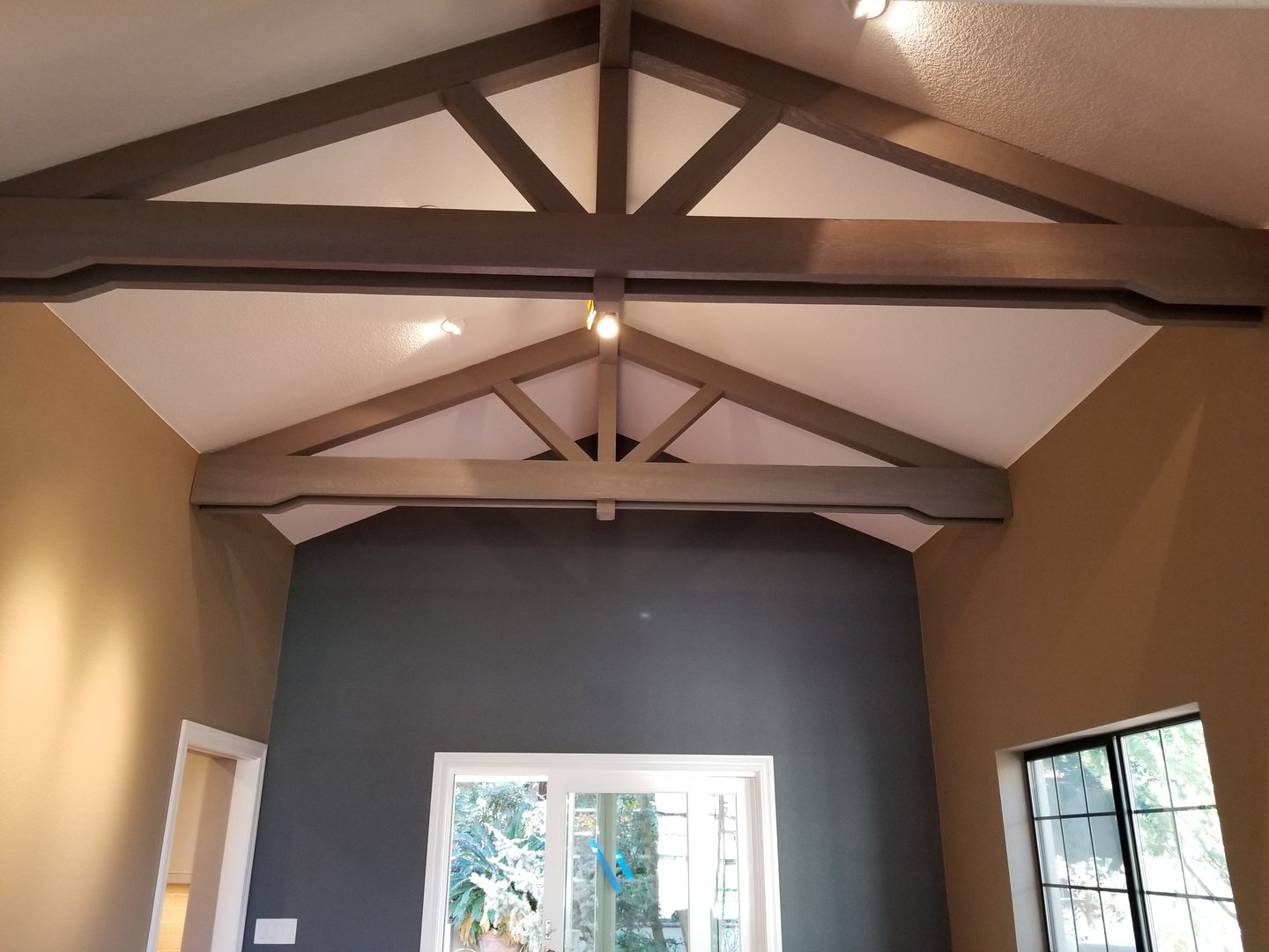 Exposed wooden beams in vaulted ceiling