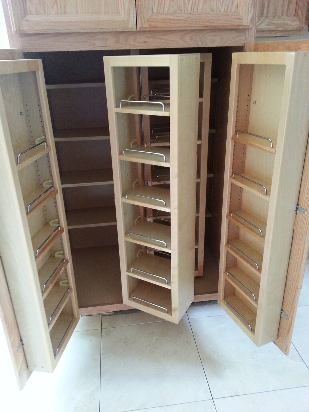 Open wooden pantry with pull-out shelves