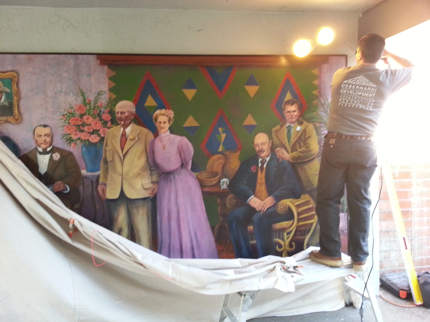 Artist working on historical mural