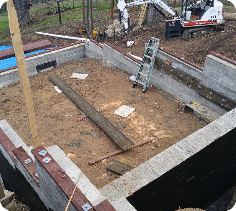 Construction site with foundation and ladder