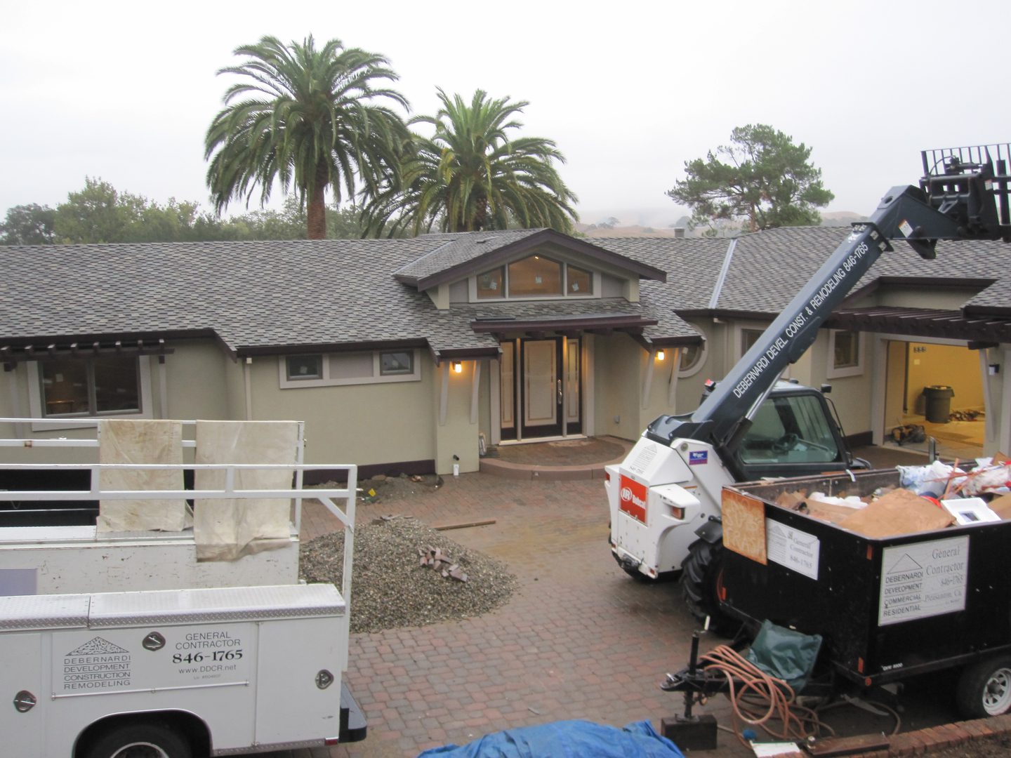 House under renovation with construction equipment