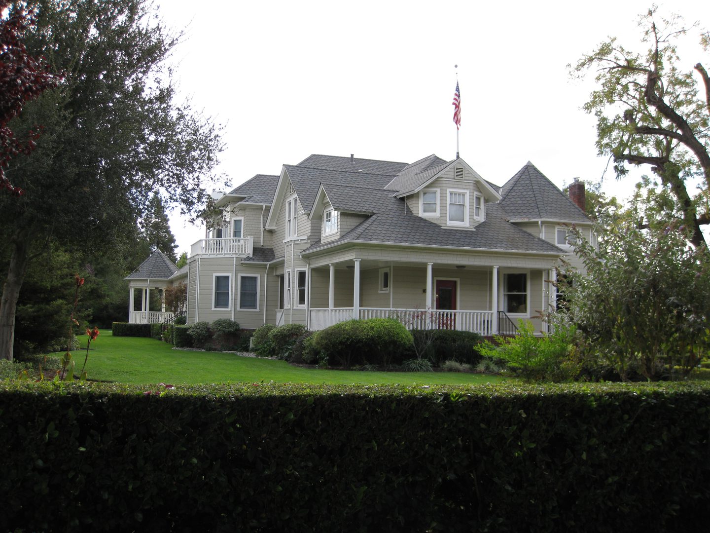 Two-story home with American flag flying