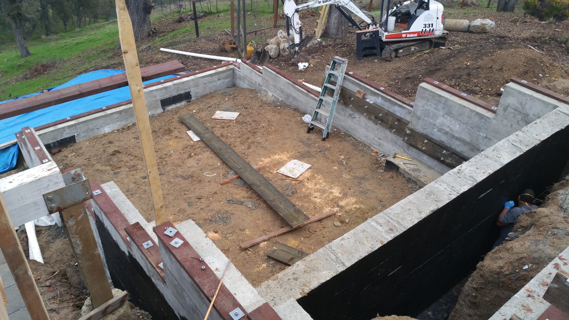 Construction site with unfinished concrete foundation.