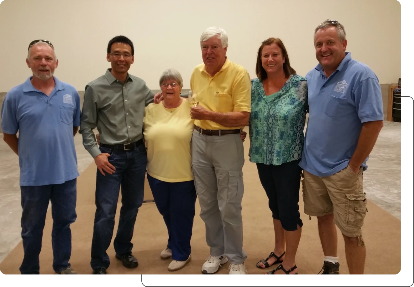 Group of six people smiling indoors